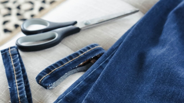 <h4><span>Cut!</span></h4><p>Use fabric (or super sharp) scissors to cut the hem off your jeans. Cut slowly and follow your chalk mark so that you have a nice straight edge. It doesn’t have to be perfect, but you don’t want it uneven (unless that’s the style you’re going for!) I like to cut the hem off one side, and use that scrap denim as a template for cutting the other side – to ensure you chop off the same amount!</p>